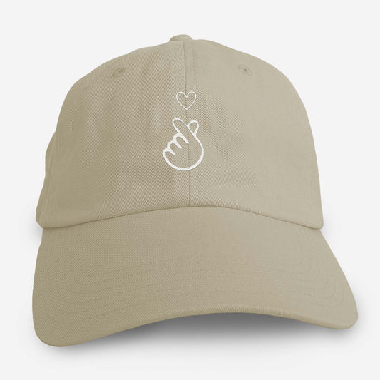 Stone colored dad hat with embroidered Asian finger heart symbol