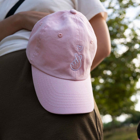 Light pink finger heart hat styled on child – cute Asian culture gift